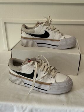 Nike White Low-Top Sneakers with Black Swoosh and Tan Accent